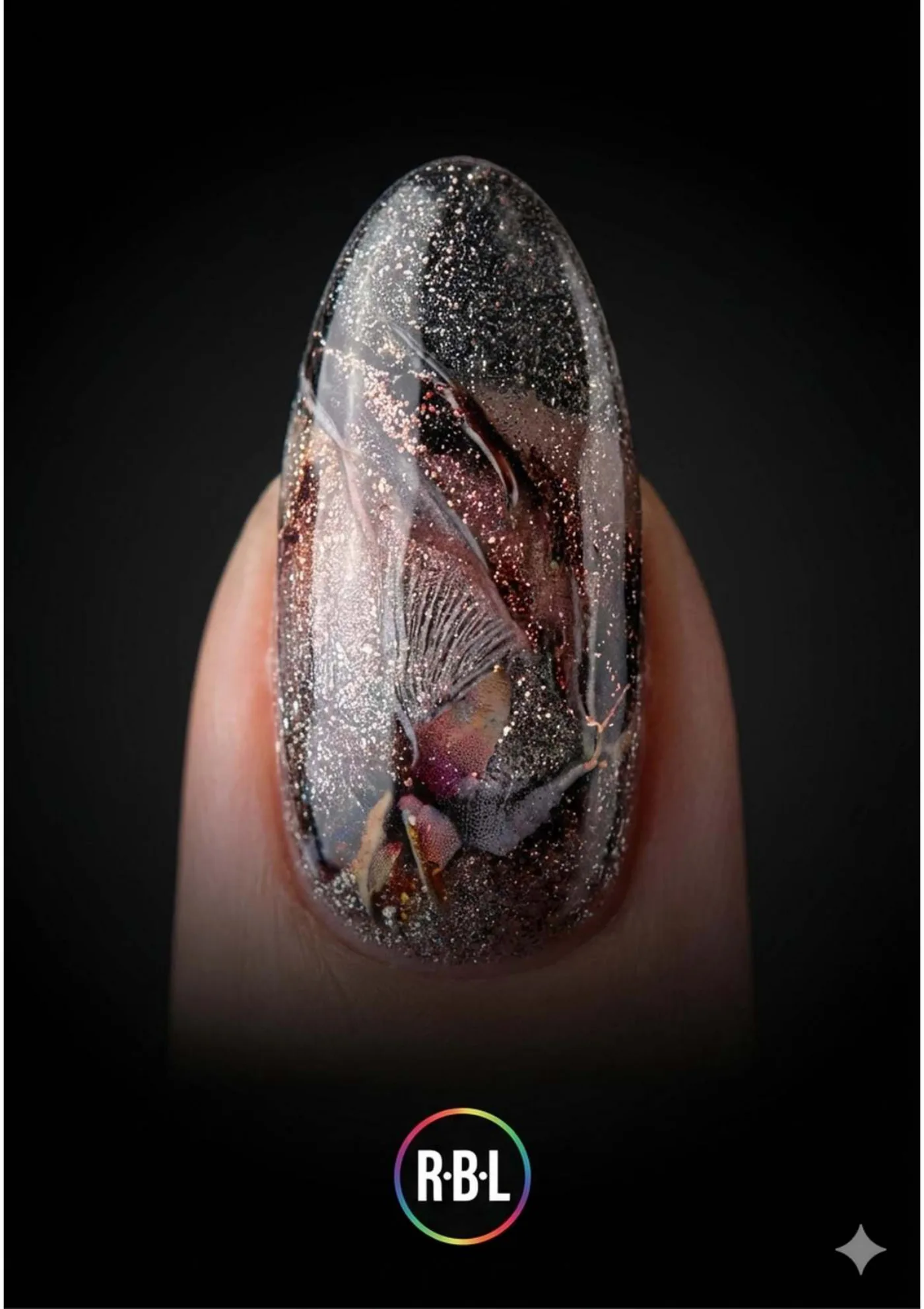 Pagina 88. Macro di una decorazione nails su fondo nero, con il logo R·B·L in basso.